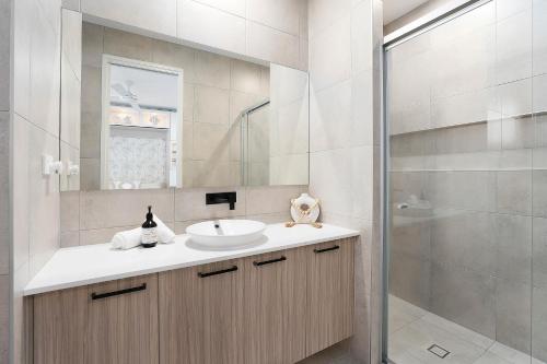 a bathroom with a sink and a shower at Luxury Golf Stay and Play in Peregian Springs