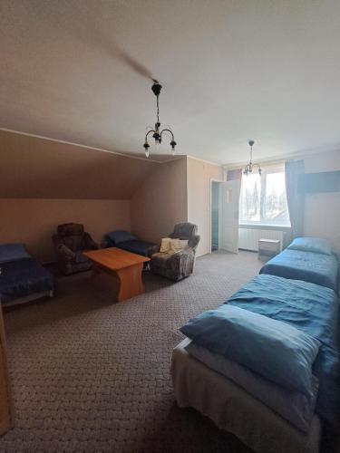 - une chambre avec 2 lits, une table et un canapé dans l'établissement Pensjonat ,,Eden'', à Degendorf