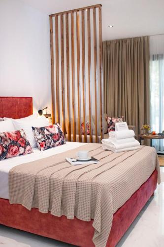 a bedroom with a large bed with a table on it at Live The Luxe in Kallithea Halkidikis