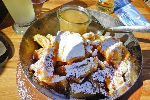 a bowl of desserts with a spoon and a drink at Chalet in Fügen near Spieljochbahn Lift in Fügen