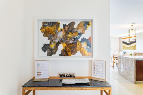 a table in a room with a painting on the wall at Mareazul Beach Front Condos At playa del Carmen in Playa del Carmen