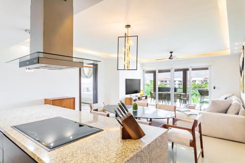 a kitchen and living room with a table and chairs at Mareazul Beach Front Condos At playa del Carmen in Playa del Carmen