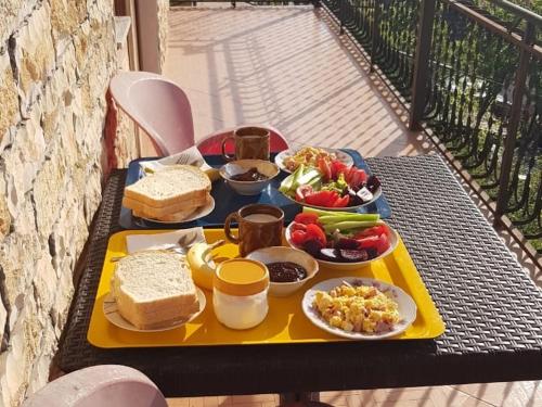 a tray of food on a table with food on it at Ensol B&B in Peshkopi