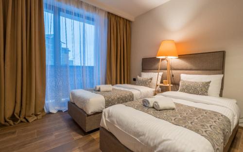 a hotel room with two beds and a window at New Gudauri Twins in Gudauri