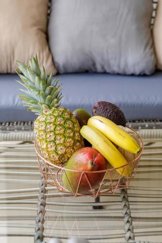a basket of fruit sitting on a table at Savvas Apartment in Tolo