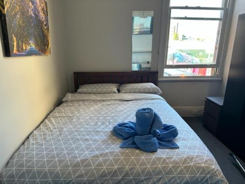 a bed with a pair of blue shoes on it at 50 Green St Windsor in Melbourne