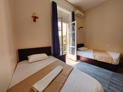 um quarto com duas camas e uma janela em Travelers House no Cairo