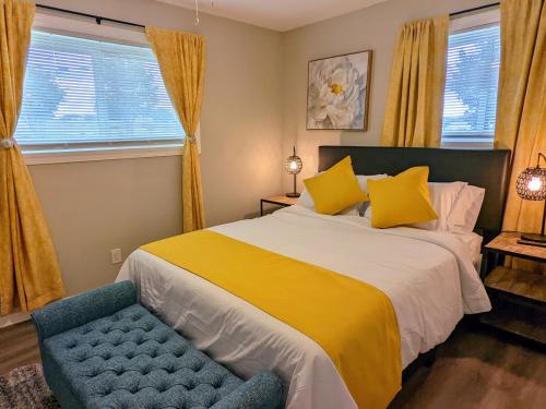 a bedroom with a bed and a blue chair at Cute Apt near Atlanta Airport-9A in Atlanta