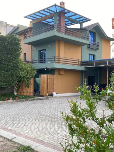 a house with a brick driveway in front of it at Vila Ajdinaj in Berat