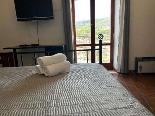 a bedroom with a bed with two towels on it at Casa di Maria in Diamante