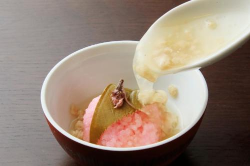 a white bowl with a spoon with a pink dessert at Yutorelo Toyako in Lake Toya