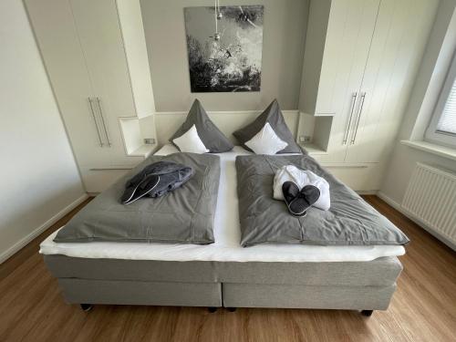 a bed in a room with two pillows on it at Ferien Bungalow Ennens in Rhauderfehn