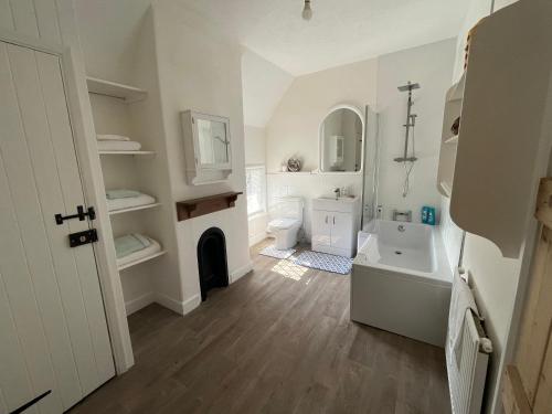 a white bathroom with a sink and a toilet at Arundel Maltravers in Arundel