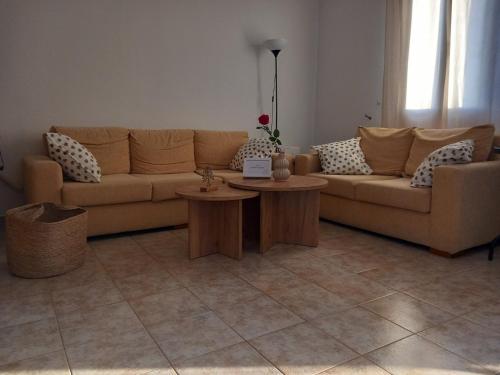 a living room with a couch and two tables at Korali in Symi