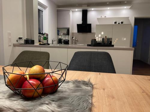 a bowl of fruit sitting on a table in a kitchen at Ferien Bungalow Ennens in Rhauderfehn