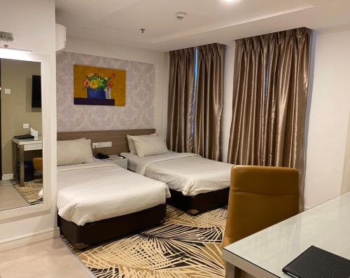 A bed or beds in a room at De Palma Hotel Shah Alam
