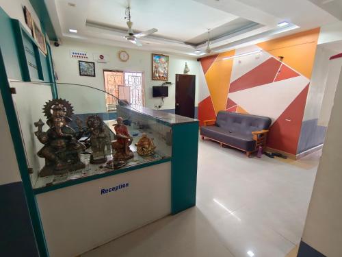 a room with a counter and a couch in a room at Sree Theja Residency in Anantapur