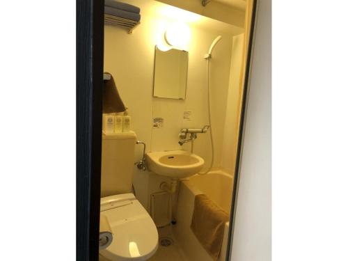 a small bathroom with a toilet and a sink at Hotel Business Villa Omori - Vacation STAY 08205v in Tokyo