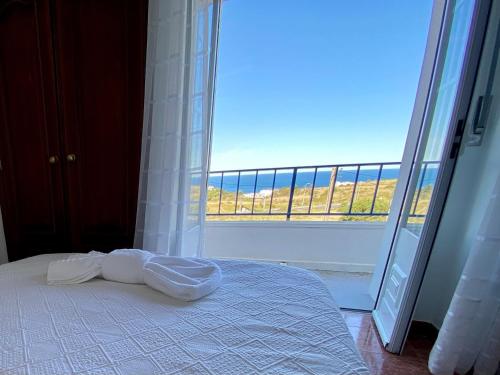 a bedroom with a bed and a large window at Ericeira Sand Beach F5 in Ericeira