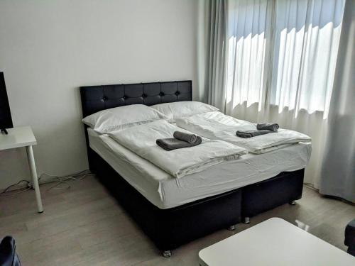 Un dormitorio con una cama con zapatos. en 306 London 59m2 4-8 Pers extra Bedroom, en Klagenfurt