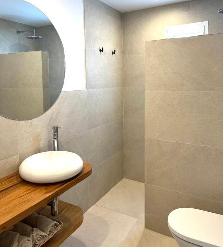 a bathroom with a white sink and a mirror at Serena Sol Apartments - Adults Only - Over 12 in Cala Serena