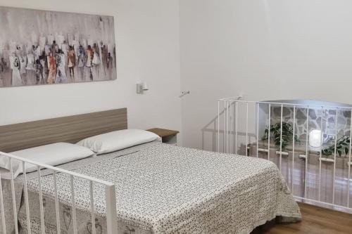 a bedroom with a bed and a picture on the wall at casetta arianna in Brindisi