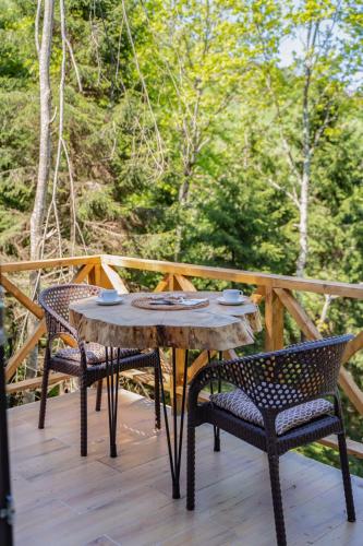 a wooden table and chairs on a deck at Montana Suite Bungalows in Trabzon