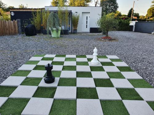 a chess board with two black and white chess pieces on it at Tropical in Mios