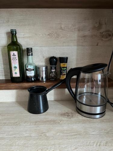 a kitchen counter with a blender and bottles on a shelf at Romantic apartments in Šibenik