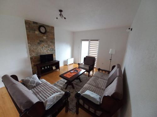 a living room with two couches and a table at Vila Bogicevic in Nova Varoš