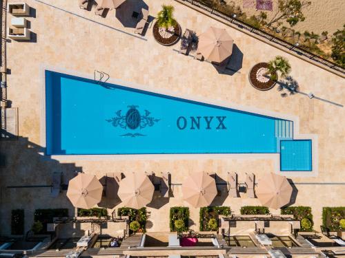an overhead view of a hotel with an omega sign and umbrellas at Onyx Beach Residence - Free Parking & Beach Access in Sveti Vlas