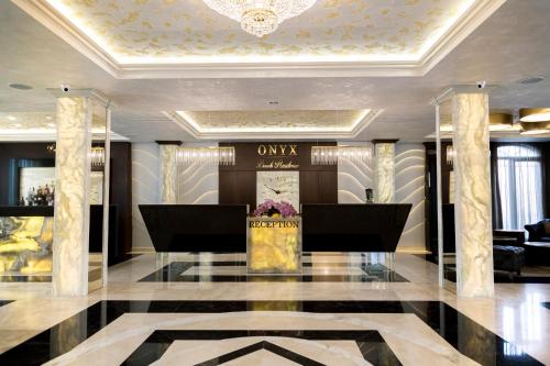 a lobby of a luxury hotel with a lobby at Onyx Beach Residence - Free Parking & Beach Access in Sveti Vlas