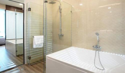 a bathroom with a shower with a glass door at Execlusive Suite 209 by Forest Khaoyai in Ban Huai Sok Noi