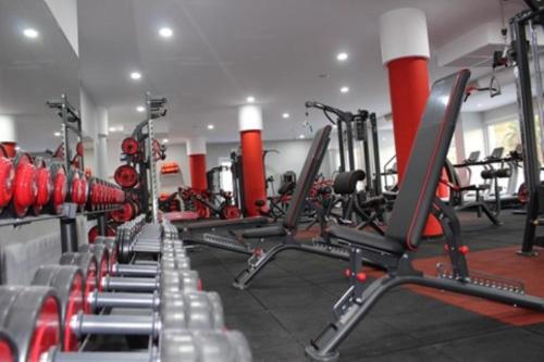 a gym with rows of treadmills and machines at OraBlu Exclusive Villas in Ischia