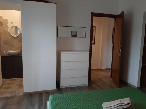 a room with a white dresser and a bathroom at alpe mare in Marina di Carrara