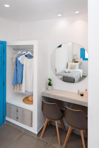 a dressing room with a mirror and two chairs at Perissa Bay in Perissa