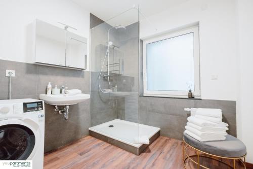 a bathroom with a washing machine and a sink at Aasee Apartment in top Lage 80m² mit 2 Schlafzimmern in Münster