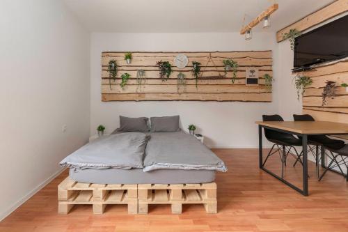 a bedroom with a bed and a desk and a table at Apartments Keber in Ljubljana