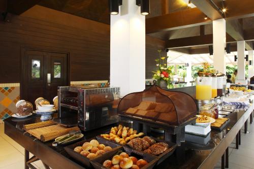 a buffet line with various pastries and other foods at Peace Laguna Resort & Spa in Ao Nang Beach