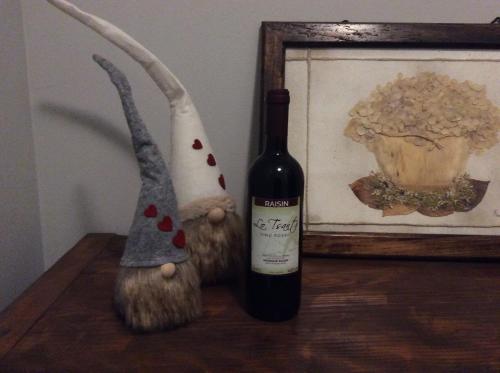 a bottle of wine next to a stuffed animal and a picture at lo Tsanty in Aosta