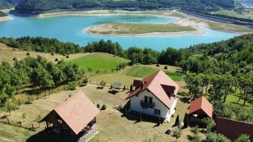 an aerial view of a house and a lake at Vila Bogicevic in Nova Varoš