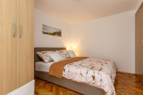 a bedroom with a bed and a wooden floor at Bernard Old Town Apartment in Split