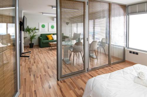 a bedroom with sliding glass doors and a dining room at Urban Downtown Suite Xanthi - MenoHomes 4 in Xanthi