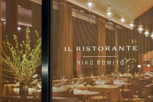 a restaurant with tables and chairs in a room at Bvlgari Hotel Tokyo in Tokyo