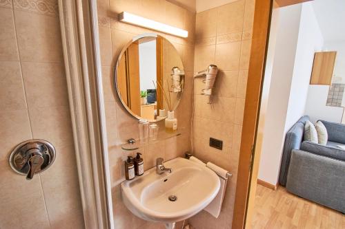 a bathroom with a sink and a mirror at Residence Isarcus in Bressanone