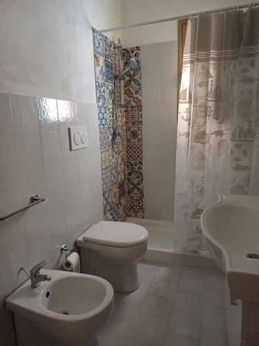 y baño con aseo, lavabo y ducha. en Soffio di Mediterraneo appartamento, en Trapani