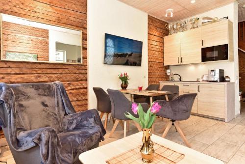 a living room with chairs and a table and a kitchen at Dalija in Druskininkai