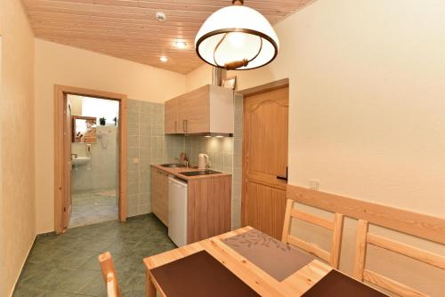 a kitchen with a table and a dining room at Dalija in Druskininkai