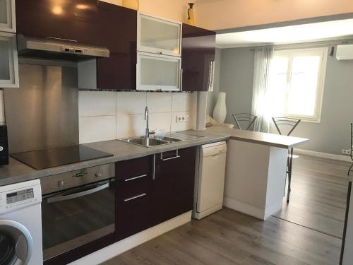 Il comprend une petite cuisine équipée d'un évier et d'un lave-vaisselle. dans l'établissement Appartement entier 3 pièces face au port, à Vallauris