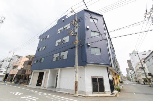 a blue building on the side of a street at マンションかわた in Osaka